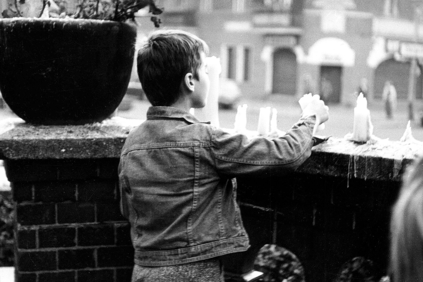 A boy lights a candle.