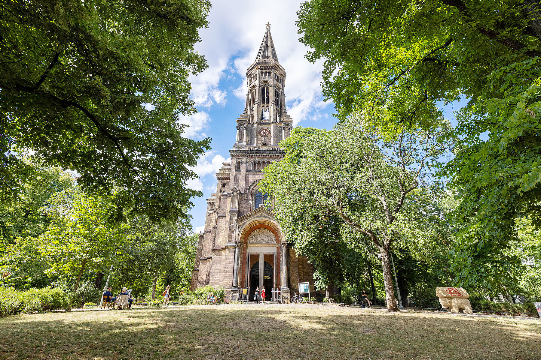 The Zionskirche surrounded by green trees.