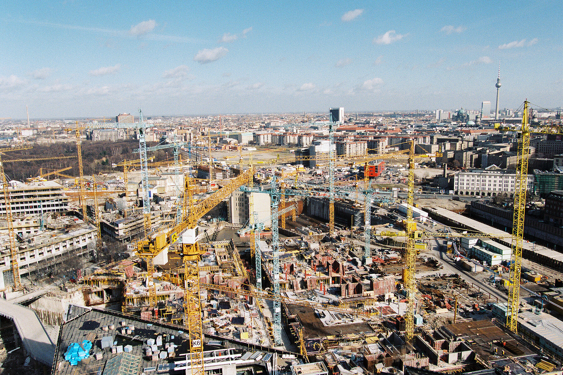 The huge construction site on Potsdamer Platz with many cranes from above.