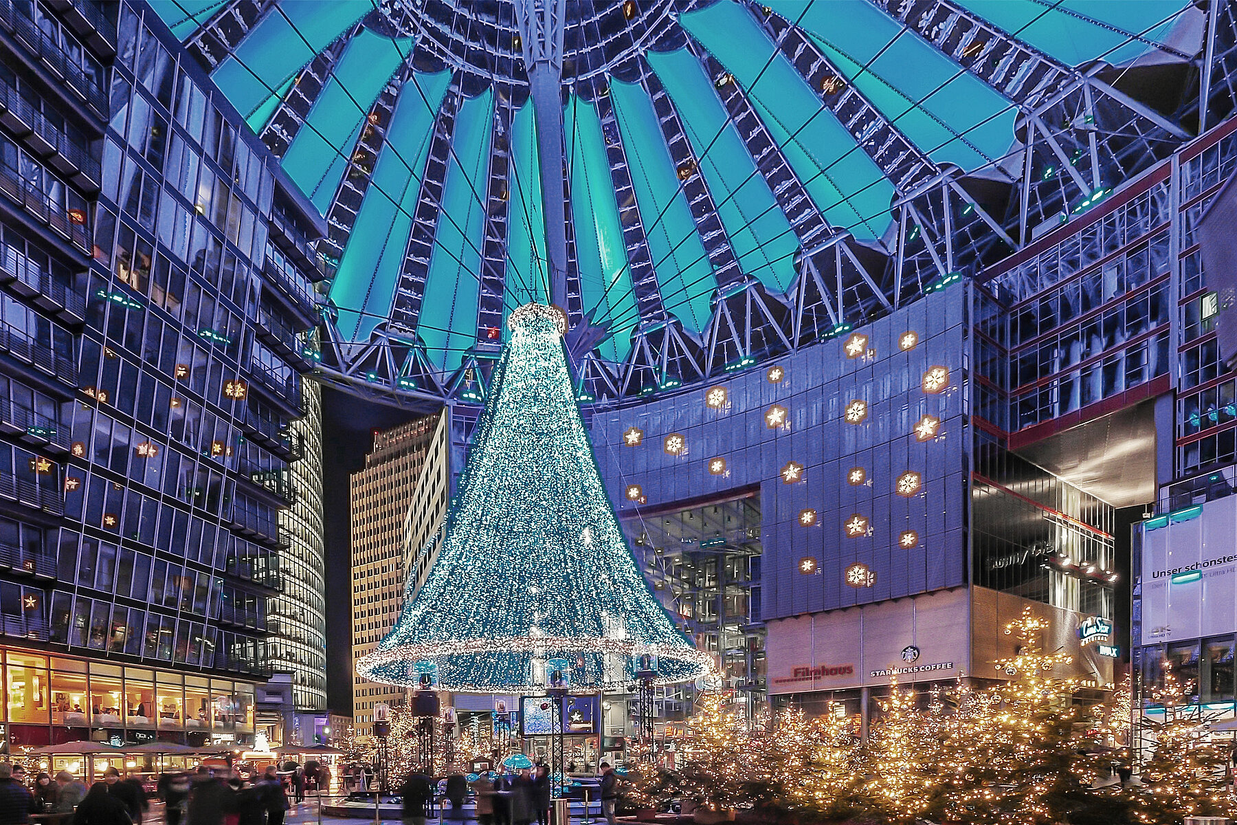 Christmas lights in the courtyard of the Sony Center, which is covered by an umbrella-like structure.