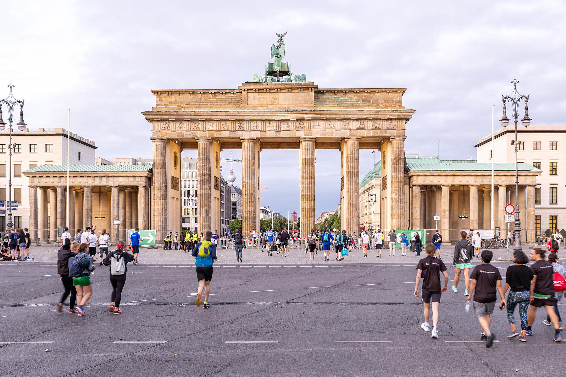 People walk through the Brandenburg Gate.